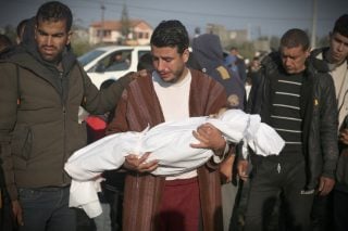 Palestinian Abdul Rahman Sharif holds the body of his four-year-old son Abdul Rahman Muamm