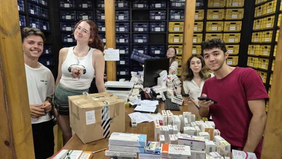 Πέντε νέες και νέοι από την Ευρώπη σε ώρα εργασίας και τακτοποίησης των χώρων του Κοινωνικού Φαρμακείου, πραγματοποιώντας ελέγχους στις ημερομηνίες λήξης των φαρμάκων